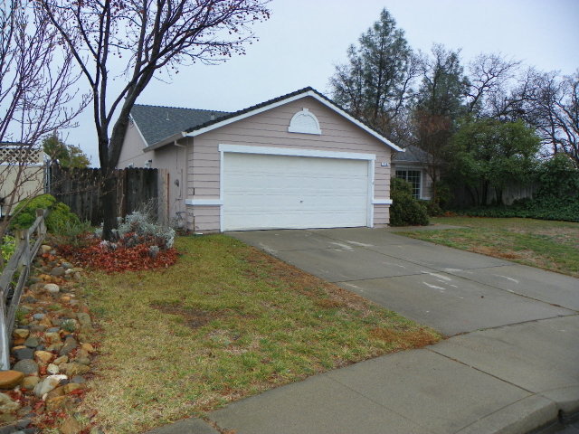 710 Mallard Street Redding, CA 96003 - Photo 2 of 19 a view of a house with a yard and garage