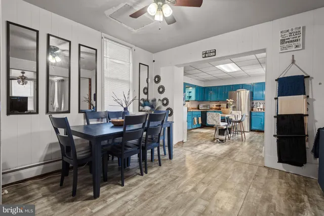 a view of a dining room with furniture and a chandelier