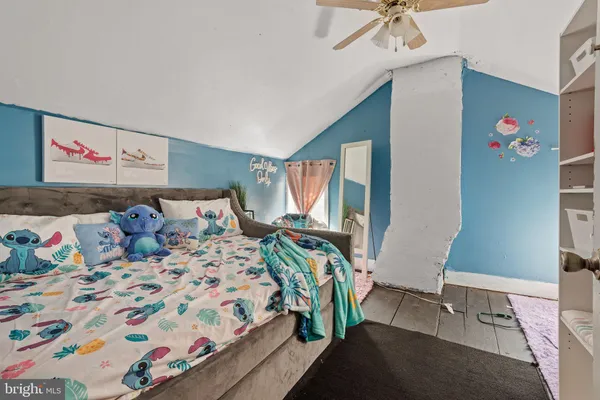 a bedroom with bed and a window