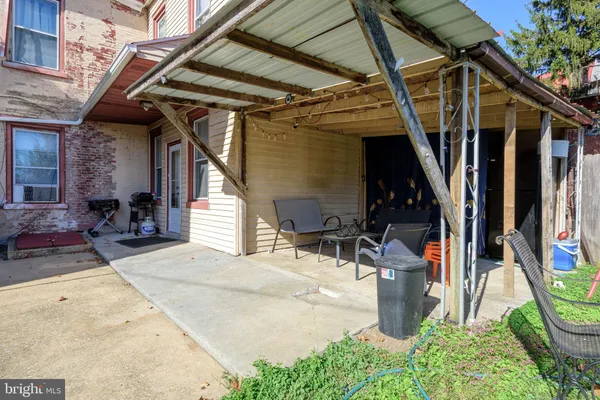 a view of a house with a backyard and a small yard