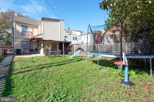 a view of a house with backyard and porch