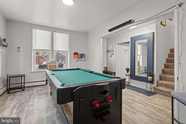 a room with pool table and windows