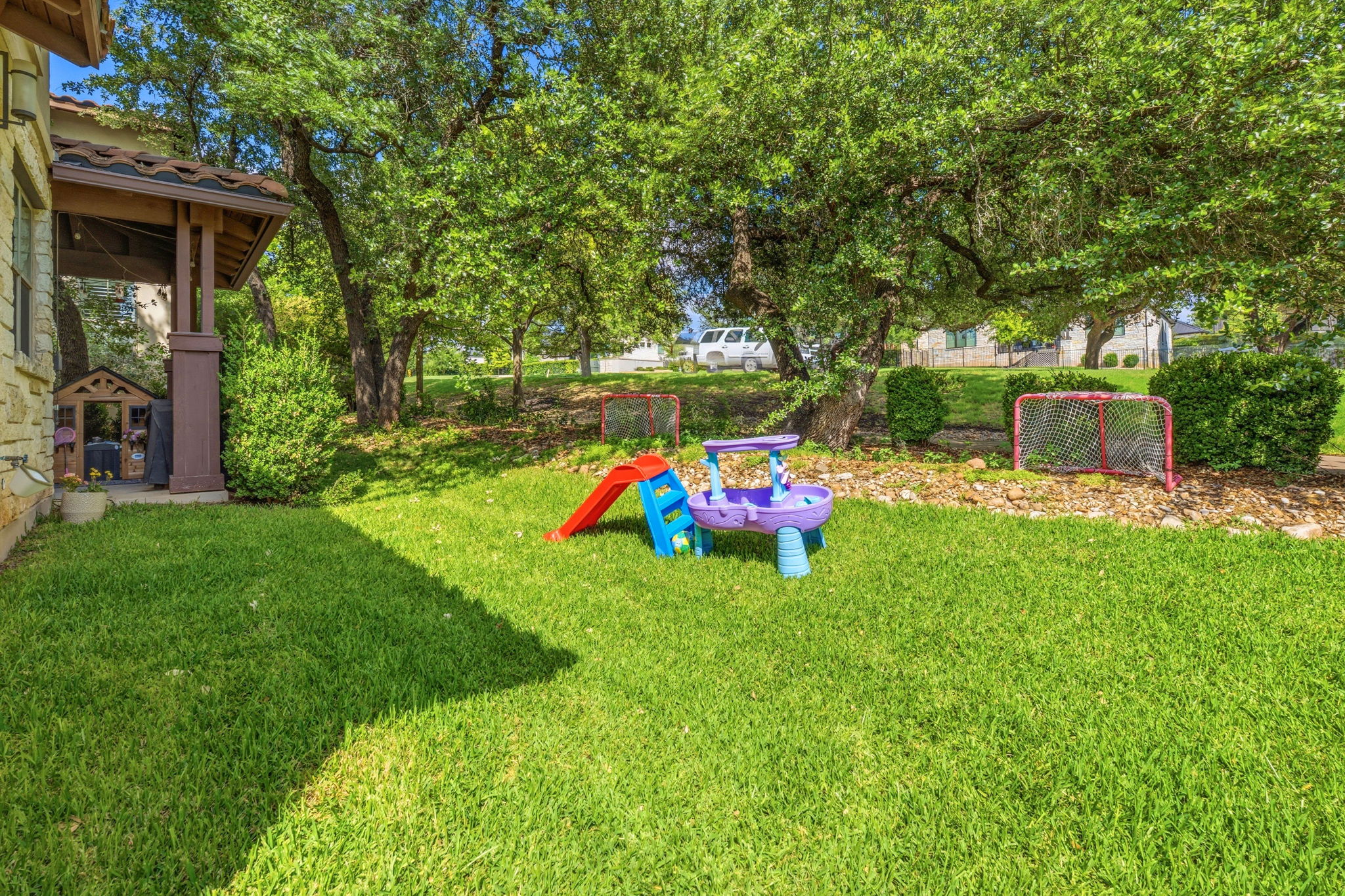 15317 Falconhead Grove Loop Austin, TX 78738 - Photo 26 of 36 Expansive grassy yard with mature trees providing natural shading