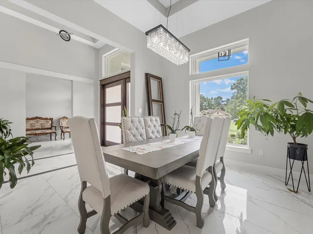 a view of a dining room with furniture and a potted plant