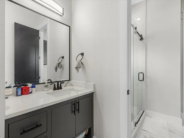 a bathroom with a sink vanity and a mirror