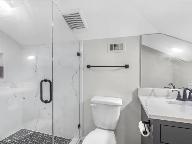 a bathroom with a toilet sink and shower