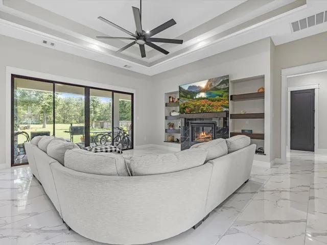 a living room with fireplace furniture and a flat screen tv