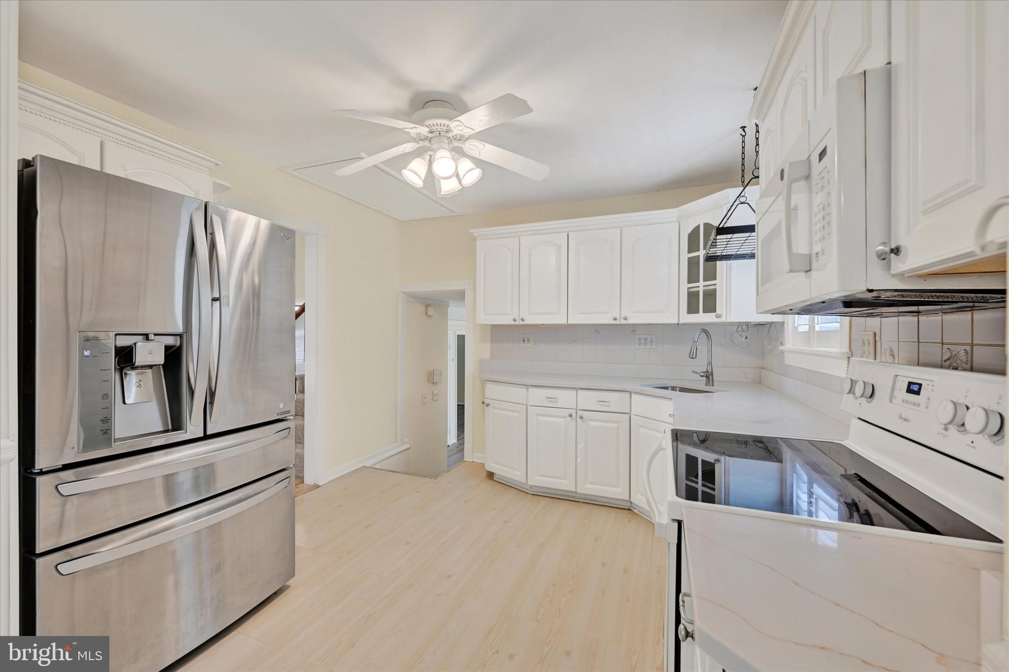809 Providence Road Towson, MD 21286 - Photo 11 of 26 a kitchen with stainless steel appliances a refrigerator sink and cabinets