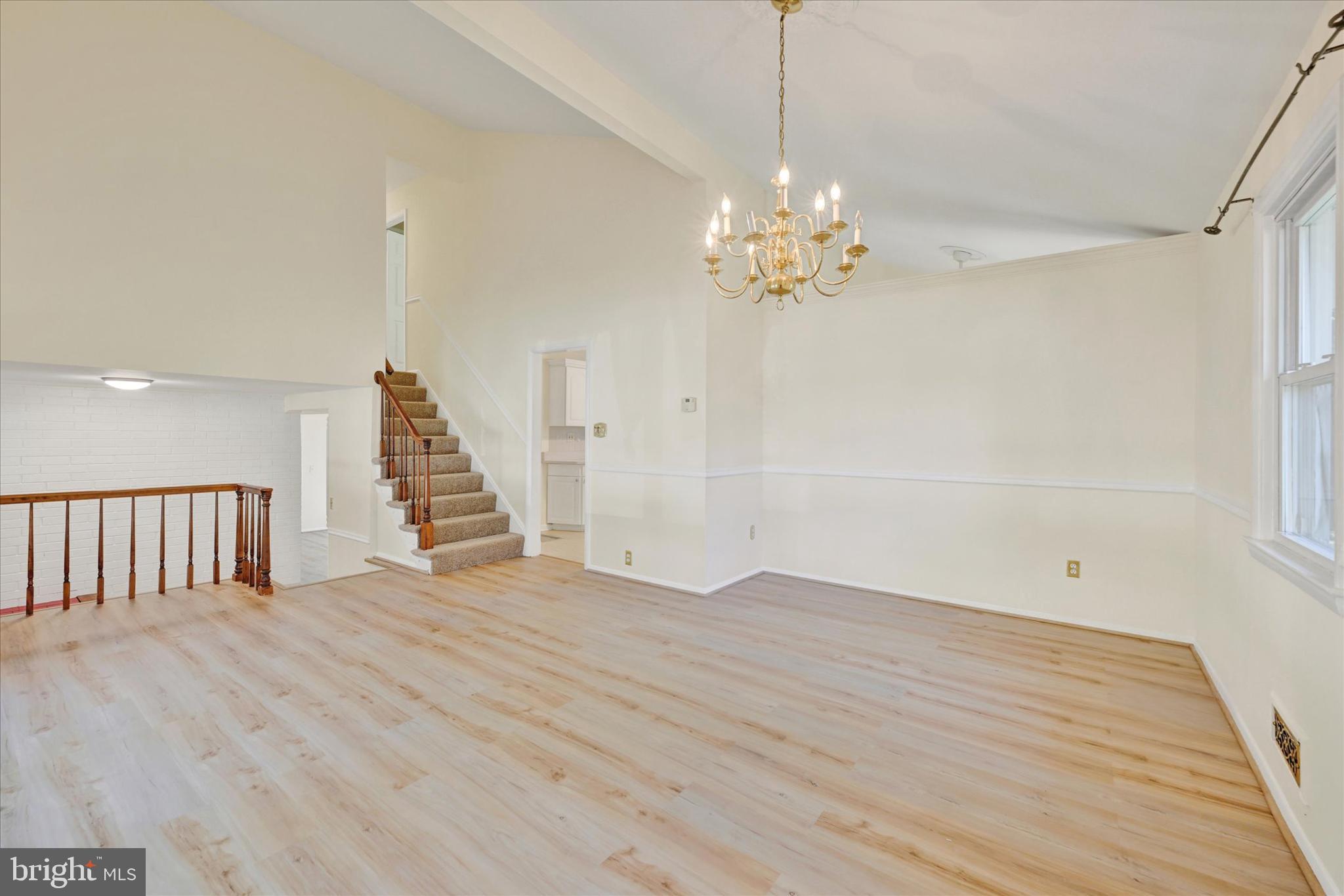 809 Providence Road Towson, MD 21286 - Photo 5 of 26 a view of an empty room with wooden floor and a window
