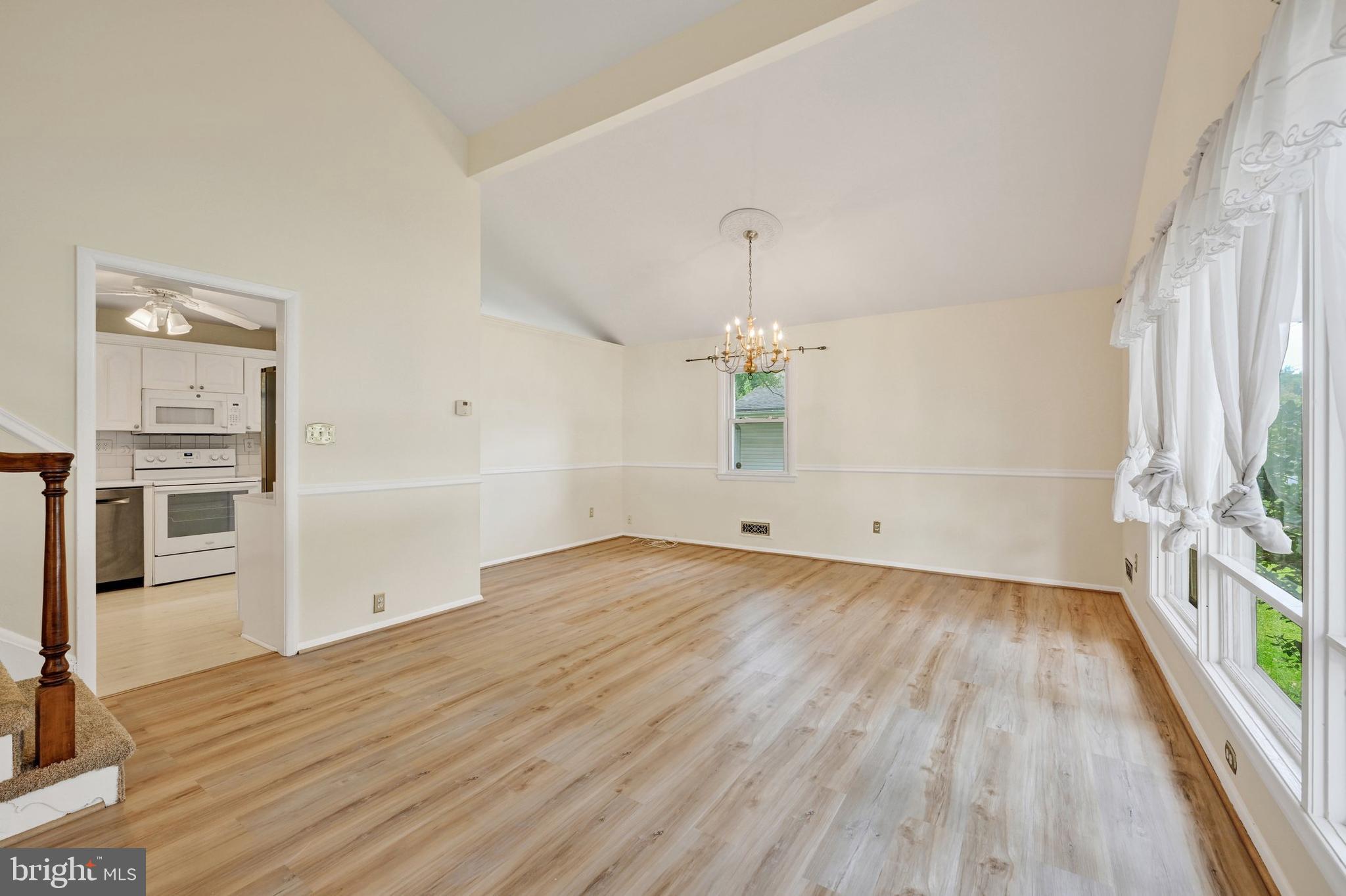 809 Providence Road Towson, MD 21286 - Photo 7 of 26 an empty room with wooden floor and windows