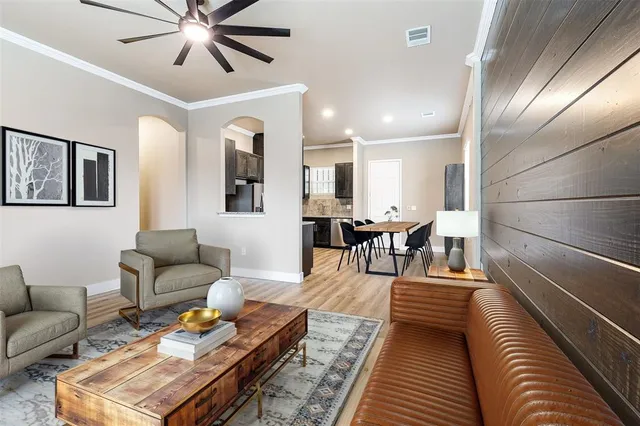 a living room with furniture and wooden floor