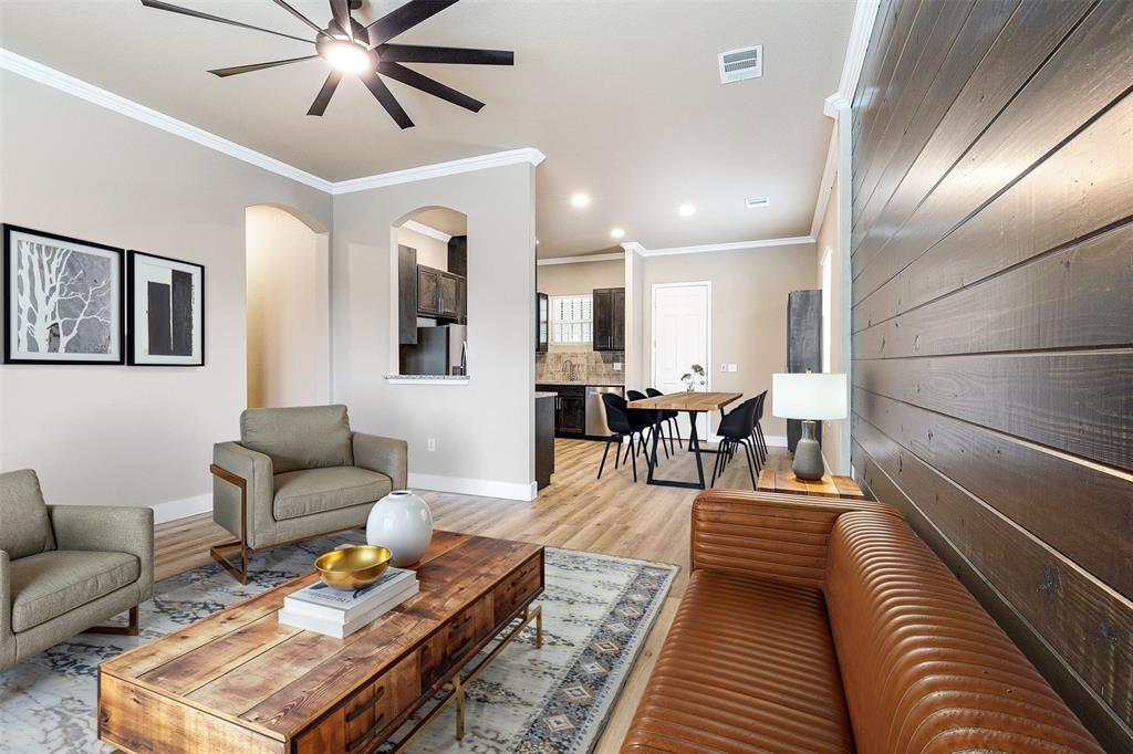 a living room with furniture and wooden floor