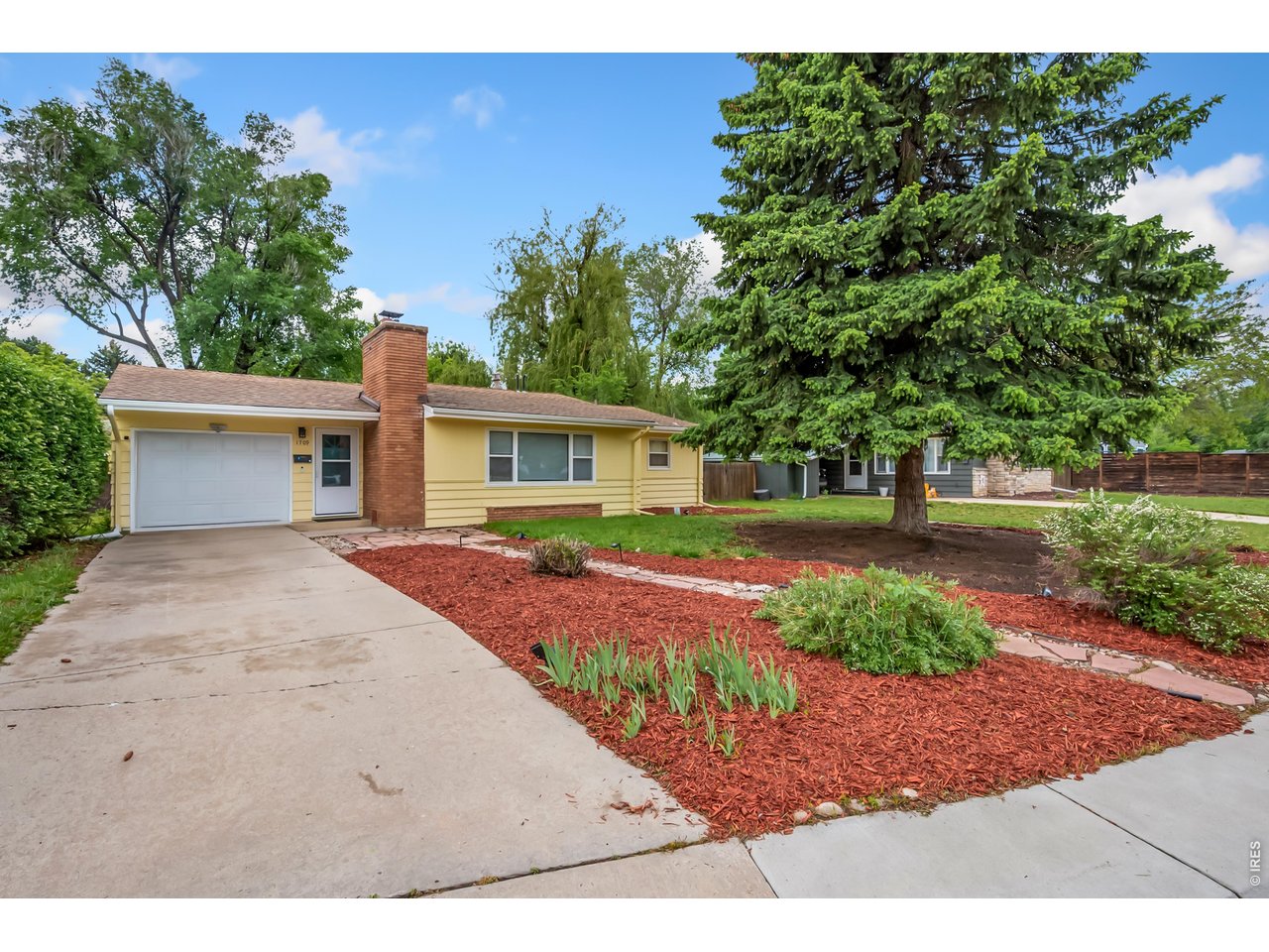 1709 Dale Court Fort Collins, CO 80521 - Photo 2 of 26 a front view of a house with a yard and a garage