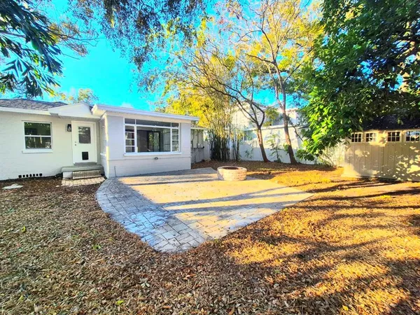 a view of house with swimming pool outdoor seating