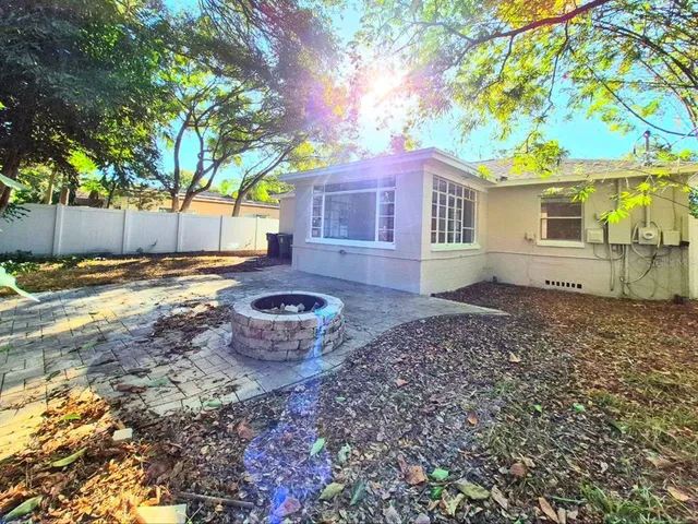 a view of a backyard with plants and trees