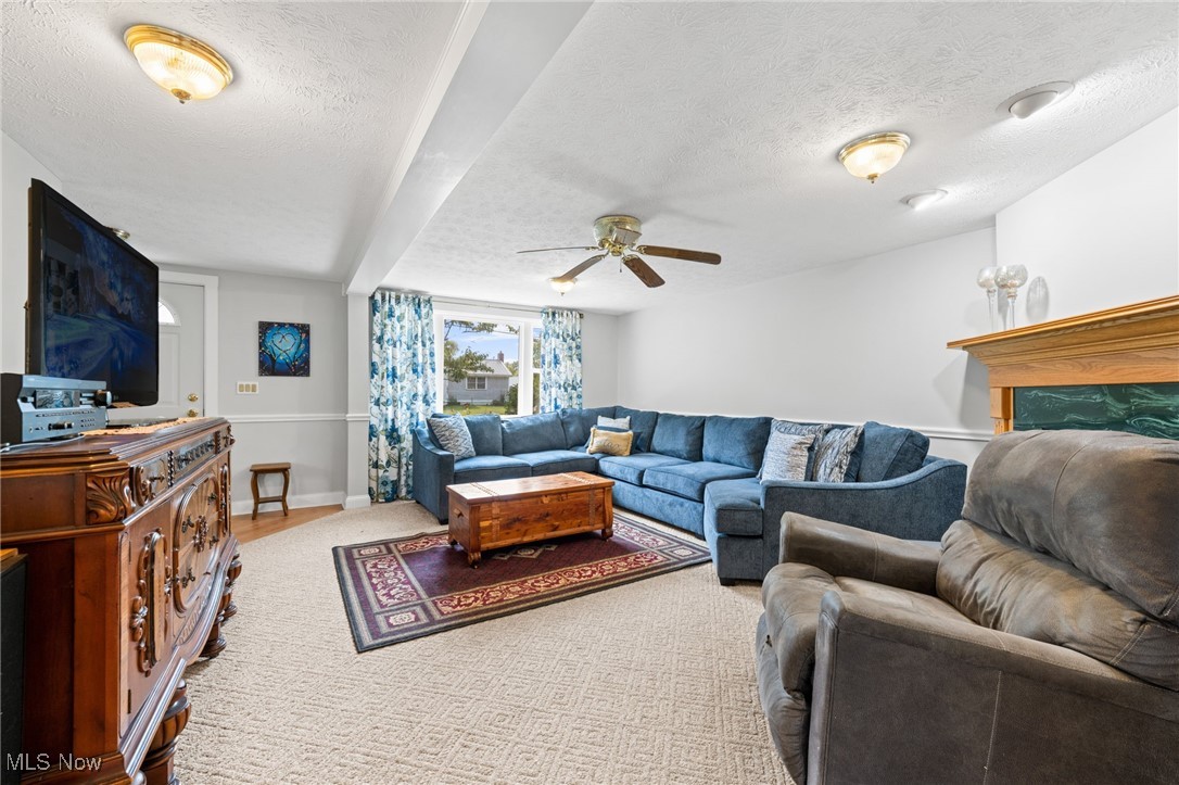3945 Columbia Road Medina, OH 44256 - Photo 16 of 40 Living area with a ceiling fan and a textured ceiling