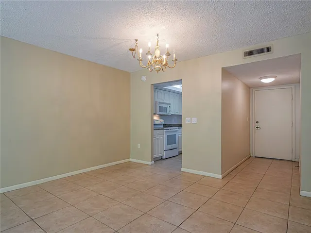 a view of a kitchen with a sink and a chandelier