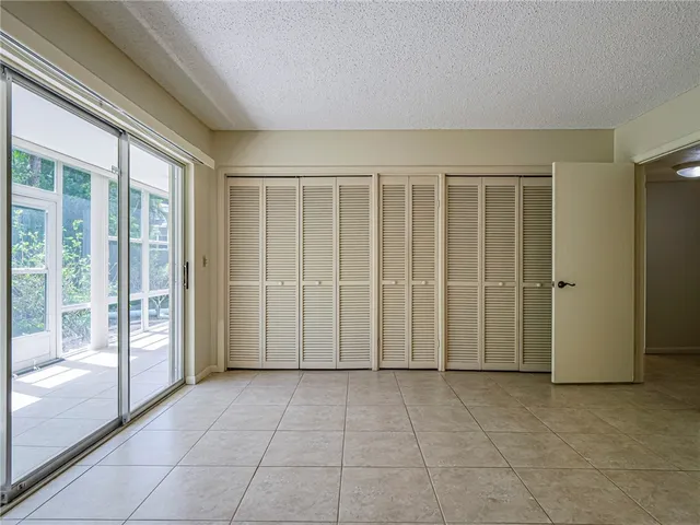 a view of an empty room with glass door