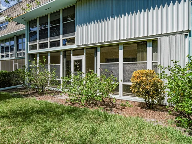 a view of a house with a window and garden