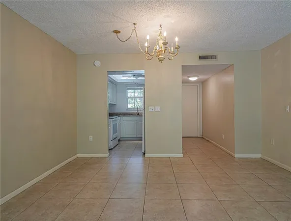 a view of a hallway with chandelier