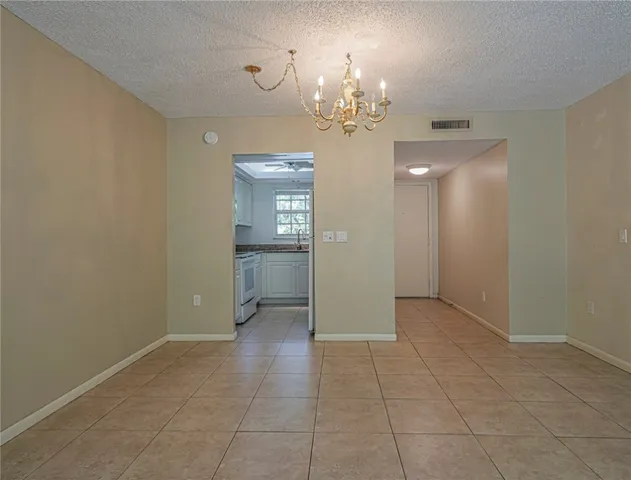 a view of a hallway with chandelier