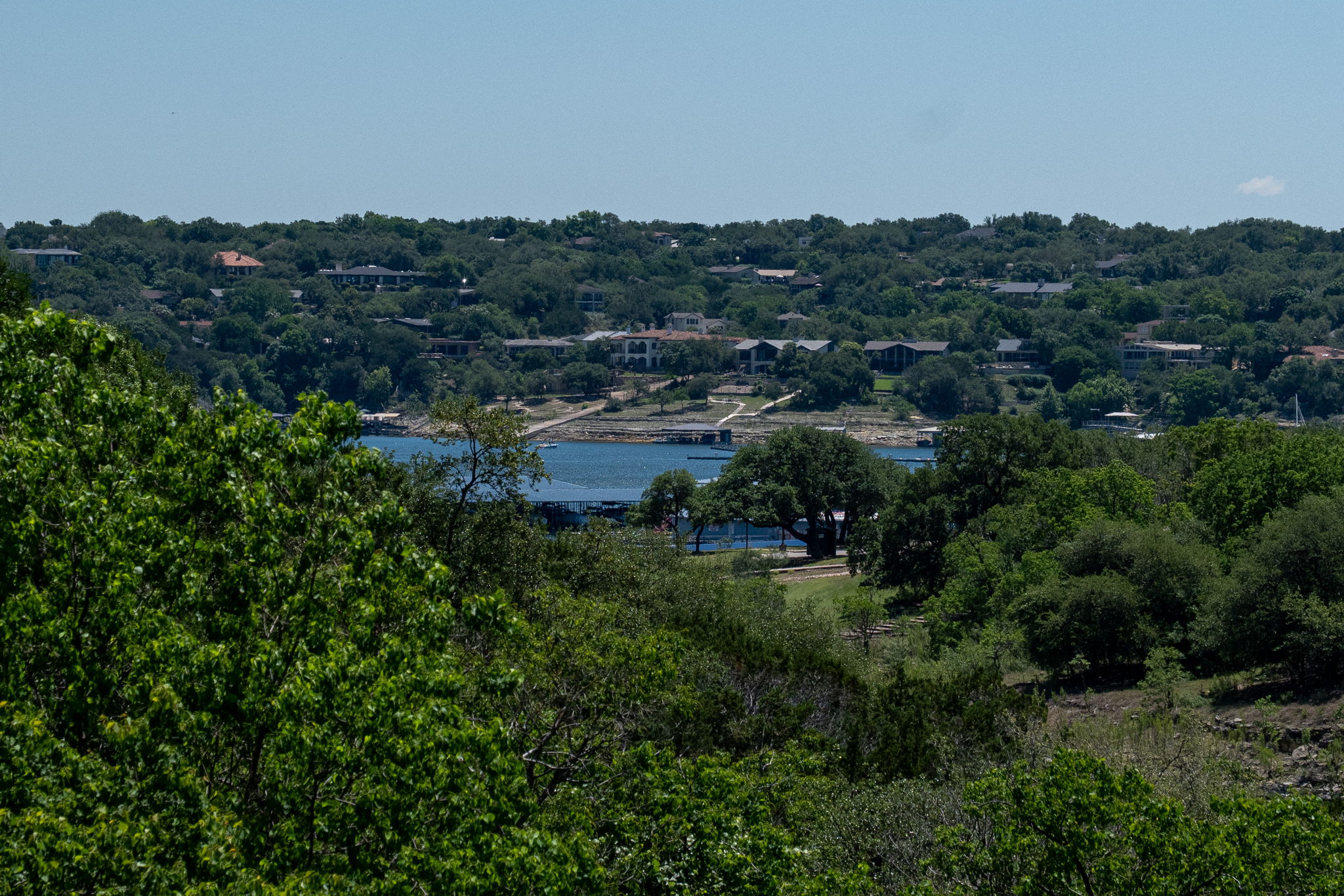433 Venture Boulevard South Point Venture, TX 78645 - Photo 3 of 36 With lake Travis shimmering in the distance, the whole setting feels peaceful and elevated.