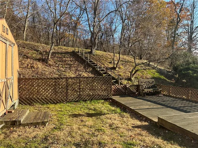 a view of a yard with wooden fence