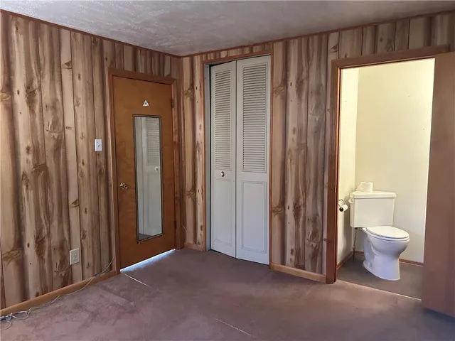 a view of a bathroom with toilet and shower