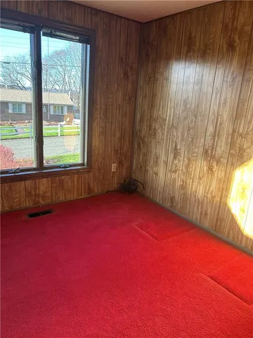 an empty room with a window and a lake view