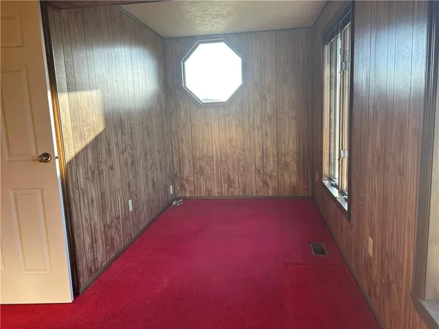 a view of an empty room and a window