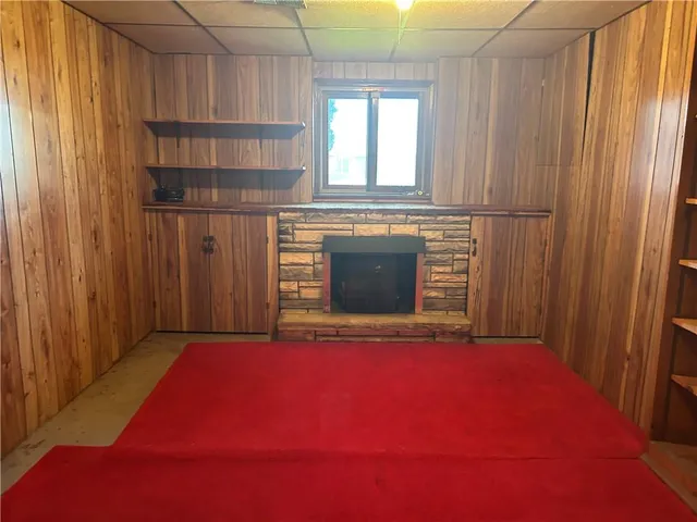 a living room with a fireplace and a window