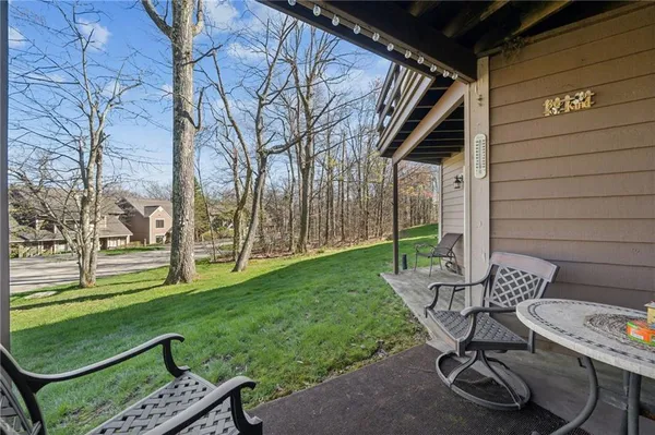 a view of a porch with chairs and backyard