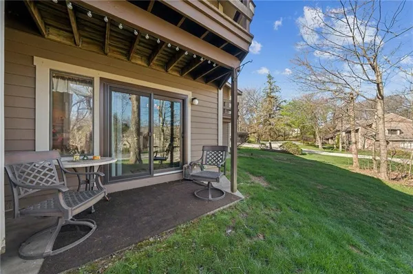 a front view of a house with a yard table and chairs