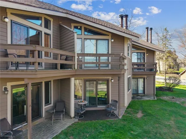 a view of house with a backyard