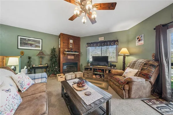 a living room with furniture a lamp and a flat screen tv