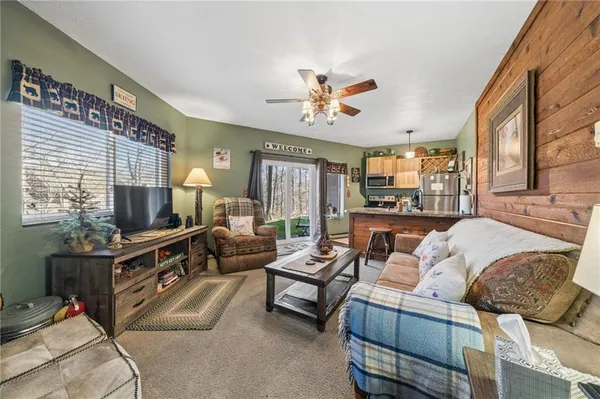 a living room with furniture ceiling fan and a window
