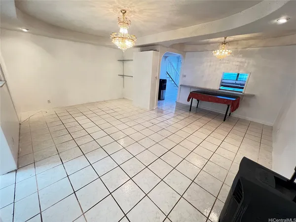 a room with pool table and windows