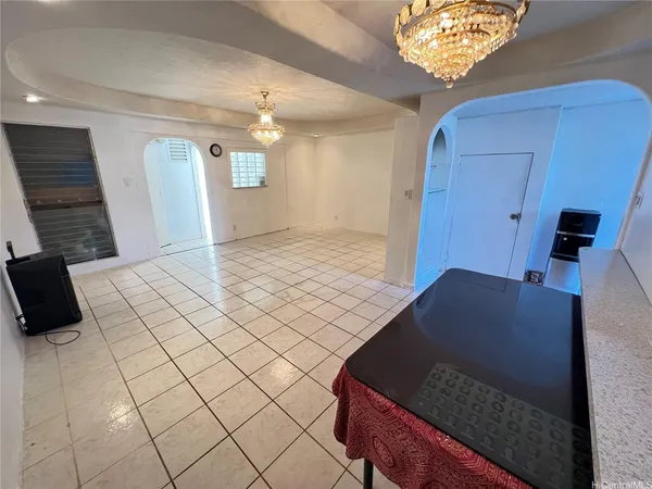 a bedroom with a bed and a chandelier