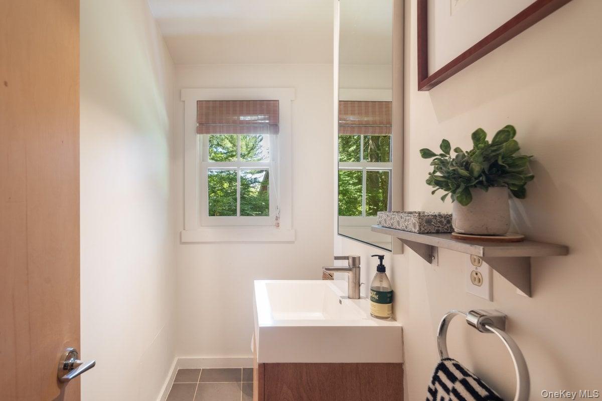 1821 Spring Valley Road Ossining, NY 10562 - Photo 25 of 48 The half bath on the main level is convenient and features the same design elements as the rest of the home.