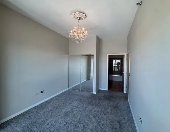 a view of a chandelier in big room and chandelier