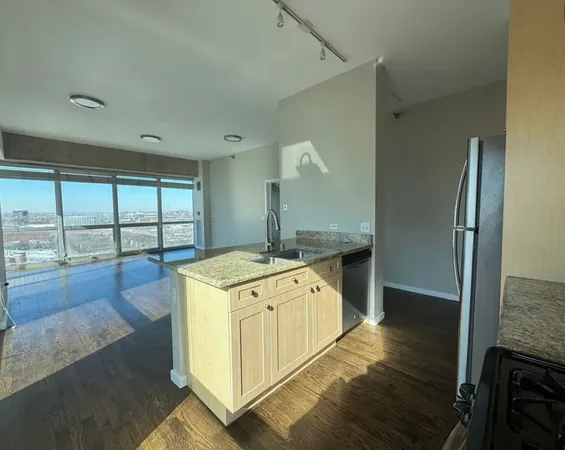 a kitchen with a stove and a wooden floors