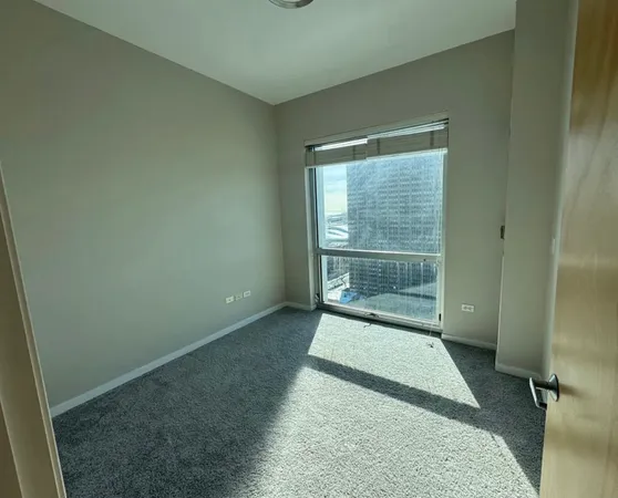 an empty room with floor to ceiling windows