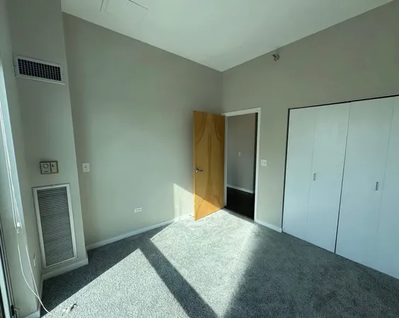 a bedroom with a bed and a mirror