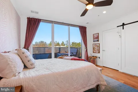 a bedroom with a bed and a large window