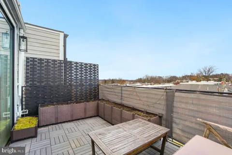 a view of roof deck with seating space and barbeque oven