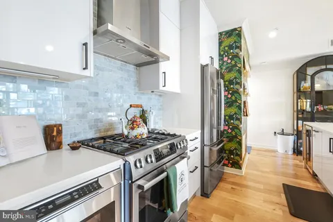 a kitchen with stainless steel appliances a stove and a refrigerator