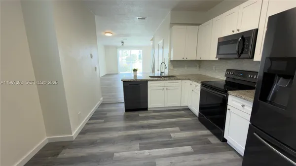 a kitchen with a sink stainless steel appliances and cabinets