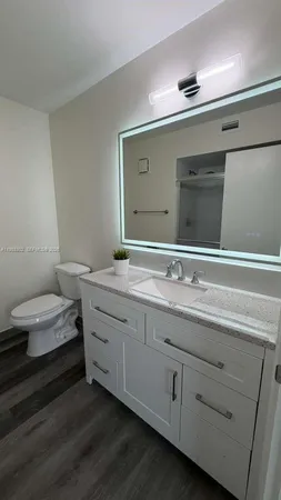 a bathroom with a double vanity sink and a toilet
