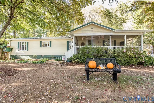 a backyard of a house with garden and outdoor seating