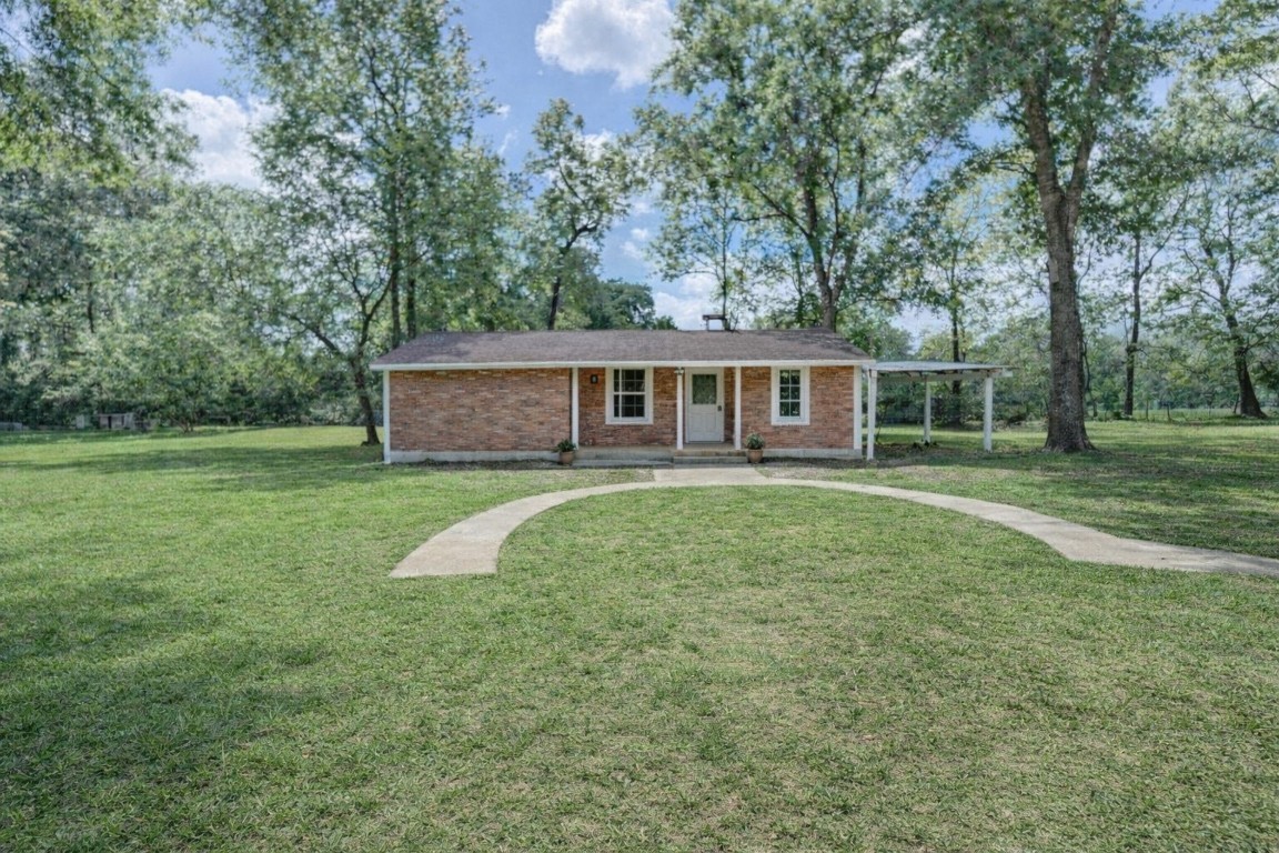 14016 Calhoun Road Conroe, TX 77302 - Photo 6 of 17 Ai generated view of cottaged with items moved out and cleaned up.